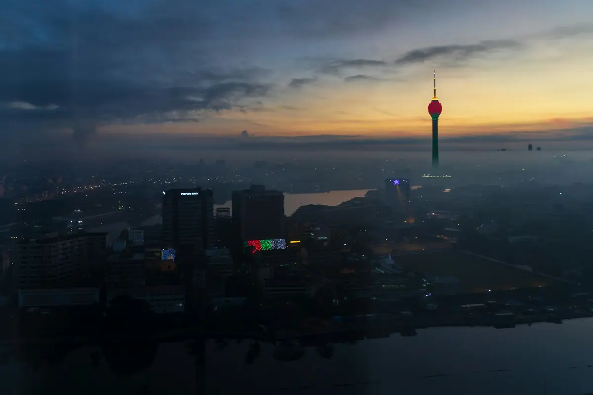 Colombo skyline at dusk with the Lotus Tower lit against an orange sky