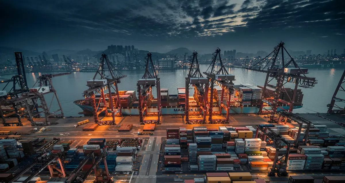 Container port at night with illuminated gantry cranes